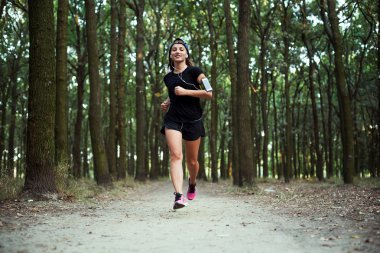 parkta çalışan genç beyaz kadın. Kadın parkta koşu