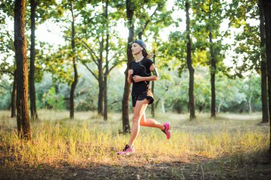 parkta çalışan genç beyaz kadın. Kadın parkta koşu
