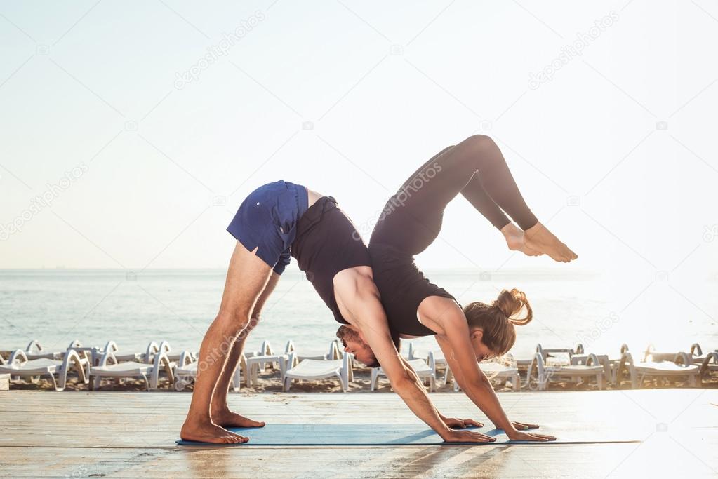 couple practicing yoga  
