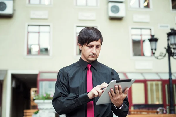 businessman using tablet outdoors