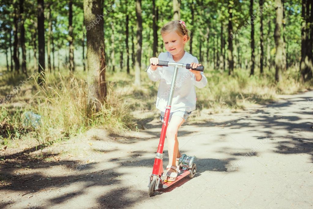 little girl riding scooter