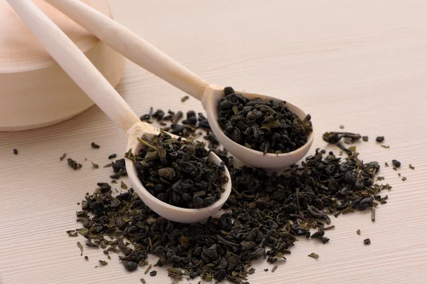 Assortment of dry tea in spoons, on wooden background — Stock Photo, Image