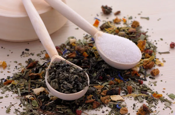 Assortment of dry tea in spoons, on wooden background — Stock Photo, Image