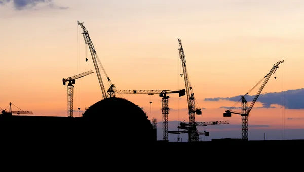 Silhouettes of nuclear power plant under construction Stock Image