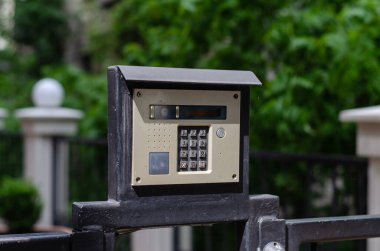 Intercom. Security system at home. Code lock on the door. Closed door.