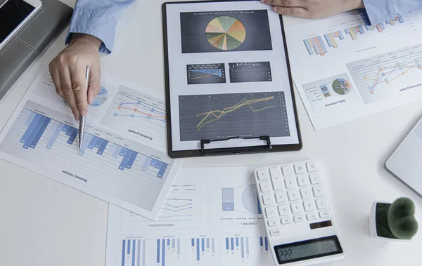 Finans işadamı şirketin kâr ve büyüme, piyasa araştırma raporları ve gelir istatistikleri, Finansal ve Muhasebe kavramları yaratma performansının grafiğini analiz ediyor.