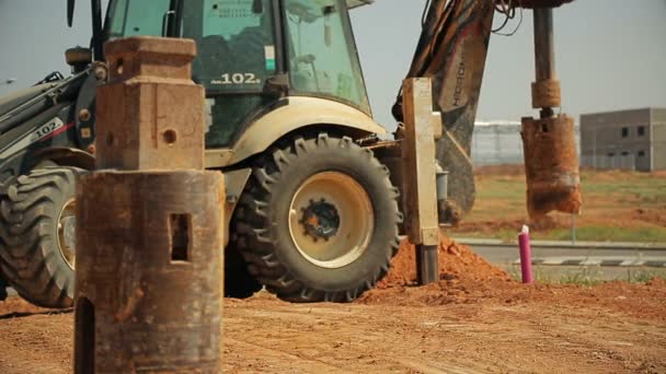 Tractor with a drilling device at a construction site — Stock Video