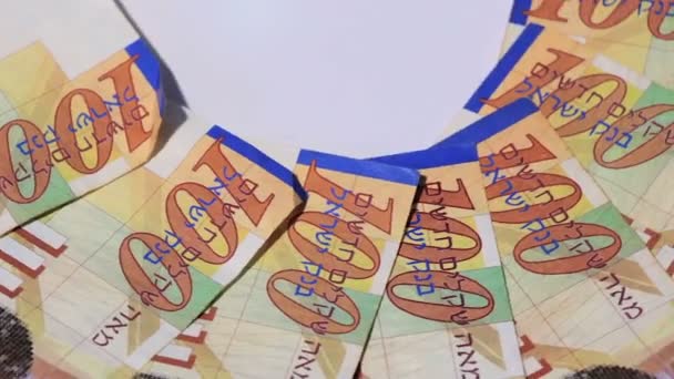 Rotating israeli money bills of 100 shekel - top view — Stock Video