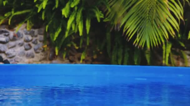 Bolhas de sabão voam sobre uma piscina e pulam na água — Vídeo de Stock