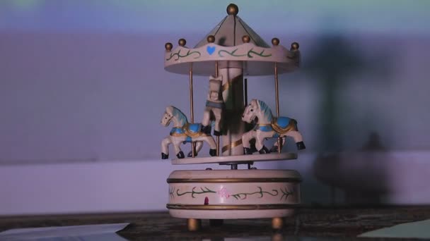 Old antique white children wooden carousel toy rotates on the floor — Stock Video