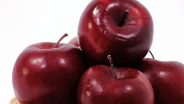 Pile of ripe red apples in wicker basket isolated on white background — Stock Video