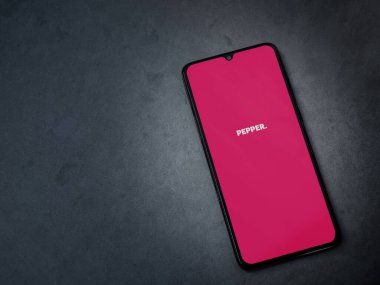 Lod, Israel - 8 Temmuz 2020: Koyu mermer taşlı arka planda siyah bir cep telefonunun logosu olan biber uygulaması fırlatma ekranı. Üst görünüm düzlüğü kopyalama alanı ile yatıyordu.