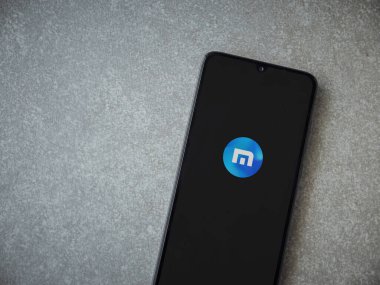 Lod, Israel - 8 Temmuz 2020: Maxthon Tarayıcı uygulaması seramik taş zemin üzerinde siyah bir cep telefonunun logosu olan fırlatma ekranı. Üst görünüm düzlüğü kopyalama alanı ile yatıyordu.