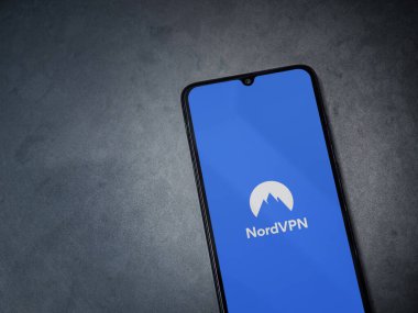 Lod, Israel - 8 Temmuz 2020: NordVPN uygulama ekranı koyu mermer taşlı arka planda siyah bir cep telefonunun logosu var. Üst görünüm düzlüğü kopyalama alanı ile yatıyordu.