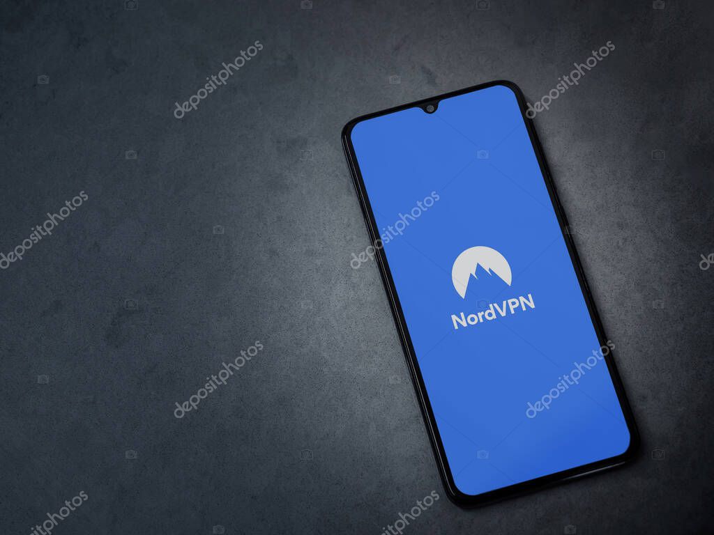 Lod, Israel - July 8, 2020: NordVPN app launch screen with logo on the display of a black mobile smartphone on dark marble stone background. Top view flat lay with copy space.