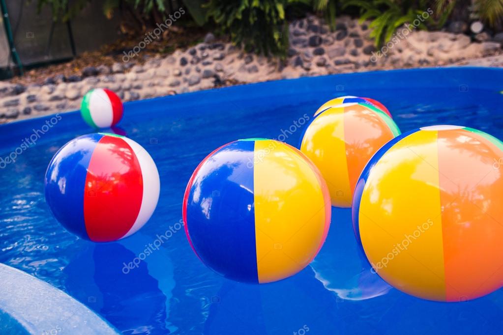 Colorful beach balls floating in pool — Stock Photo © wavemoviesmw