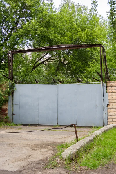 Portão de metal velho na entrada da planta — Fotografia de Stock