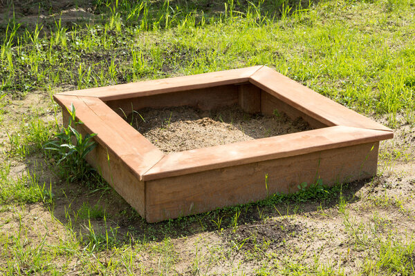 коричневые дети деревянная песочница на земле
