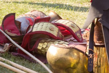 Ancient Roman armor of leather and metal lying on ground clipart