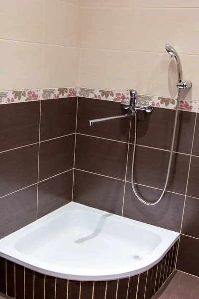 Shower tray in the bathroom lined with brown tiles — Stock Photo, Image