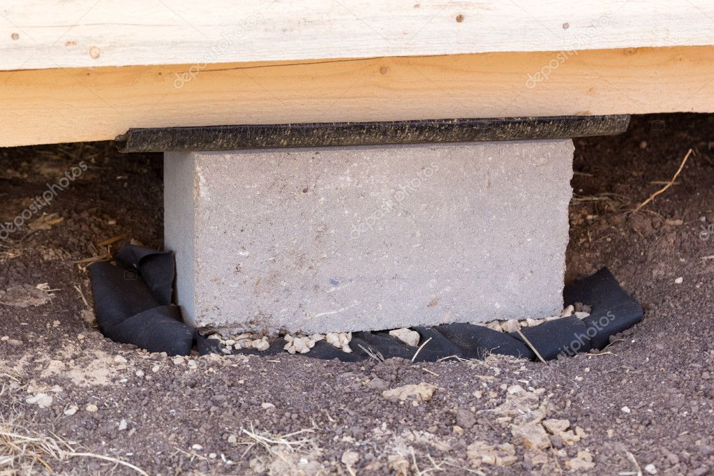 cement foundation block under wooden construction