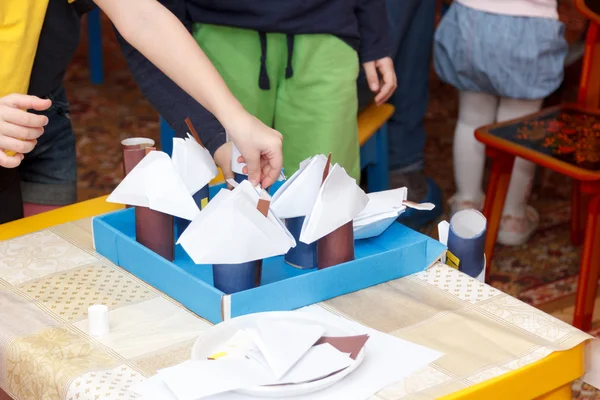 several paper crafts houses on desk