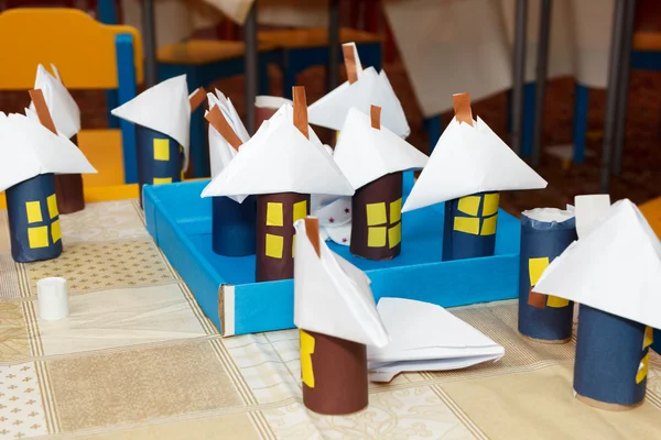 several paper crafts houses on desk