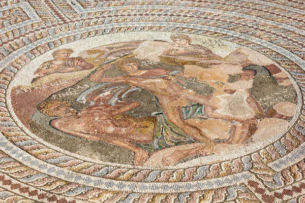 Mosaic with Minotaur in Kato district, Paphos, Cyprus. Floor tile pattern inside ruined House of Theseus. Ancient Greek ornament of home interior in old Paphos city. Small stone textured surface.