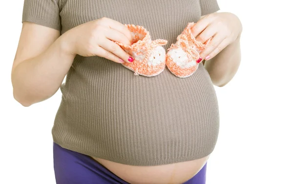 Pregnant woman holding baby's bootees — Stock Photo, Image