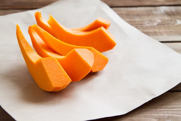 Pumpkin slices on parchment paper — Stock Photo, Image