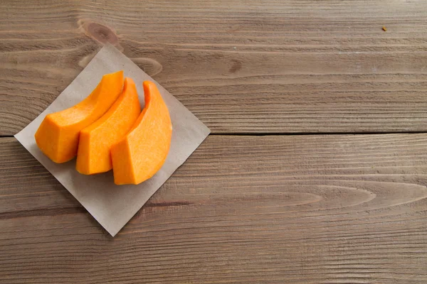 Pumpkin slices on parchment paper — Stock Photo, Image