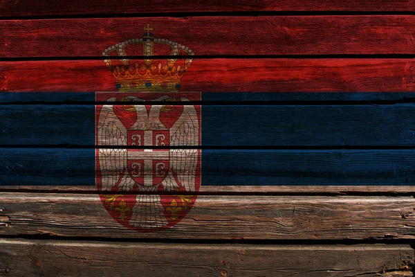 3D Flag of Serbia on a old wood wall background.