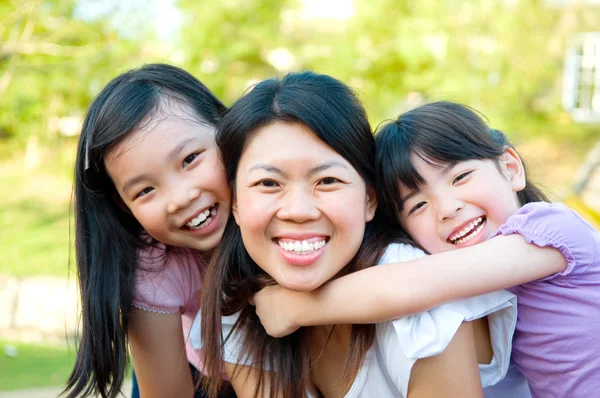 Cheerful asian mother and daughters — Stock Photo, Image