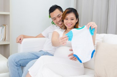 Asian pregnant woman and husband clipart