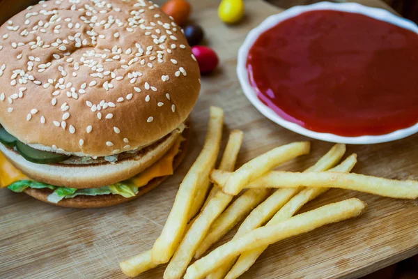 Fast food büyük hamburger ve patates kızartması ahşap arka plan ayarla — Stok fotoğraf