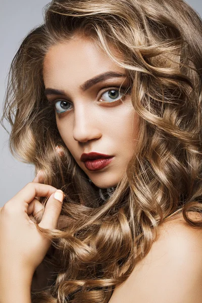 Uzun dalgalı saçlı güzel kız. curl ile sarışın model