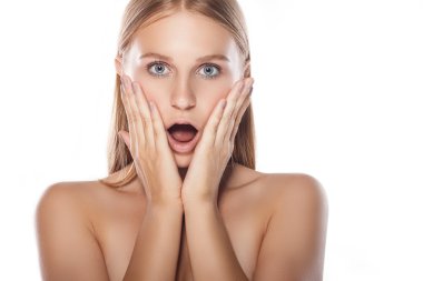 Young woman surprised and put her hands to her face. Woman on a 