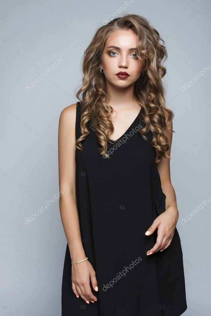 Stylish beautiful girl in a black dress in the studio isolated. Stock Photo by ©alexandrporubaymykh 124305428 Stylish beautiful girl in a black dress in the studio isolated. Stock Photo by ©alexandrporubaymykh 124305428