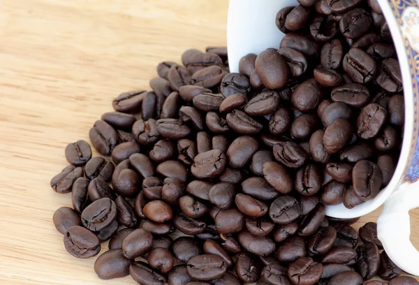 Coffee beans on wood — Stock Photo, Image