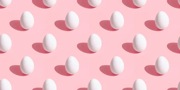 Chicken eggs pattern on a pink background. . Easter eggs pastel background.