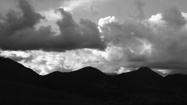 Pluizige wolken boven de bergen — Stockvideo