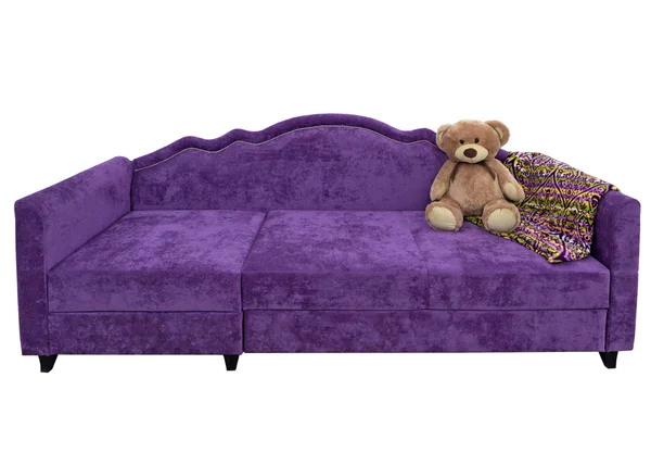 Ведмідь на м'якому фіолетовому дивані — стокове фото