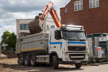 İsveç 'in güneyinde bir inşaat alanındaki kamyona çakıl taşları yüklemek..