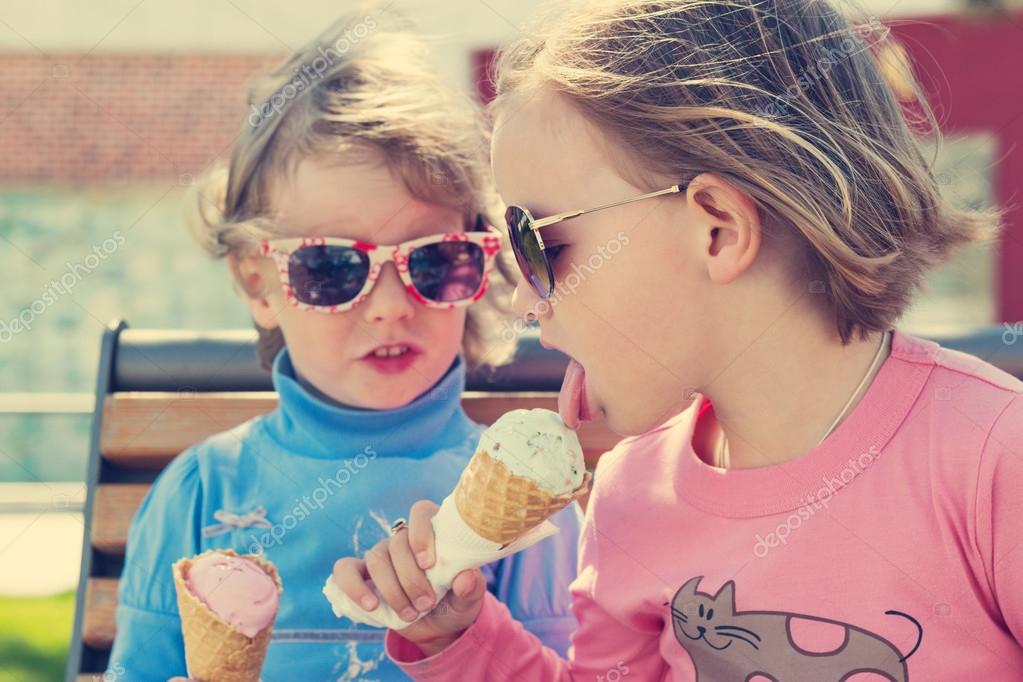 Two little girls eating ice cream. — Stock Photo © iuliia29photo 72396859