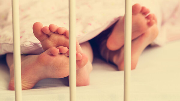 Little baby legs under the blanket.