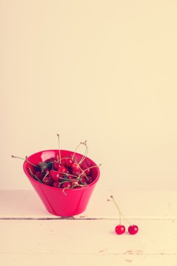 Ripe cherries on a red plate. Selective focus.