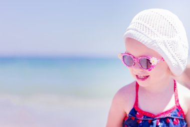Beautiful little girl laughs on the background of the sea on the