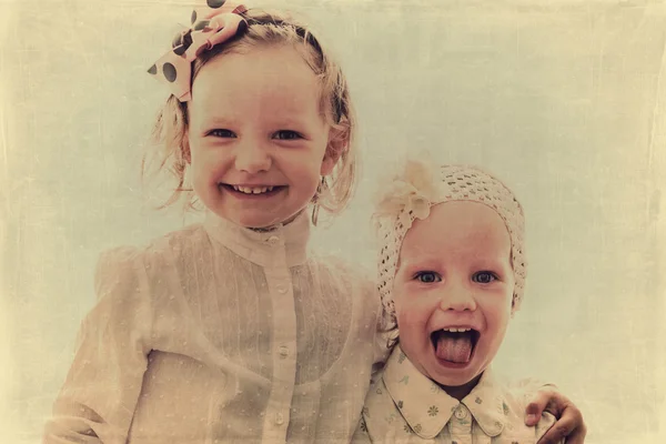Portrait of beautiful little girls (sisters)  in vintage style.
