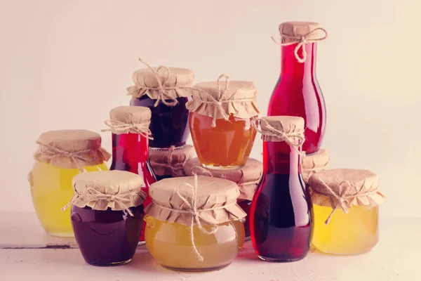 Preserved homemade fruits and berries jam in the jar. Rustic sty