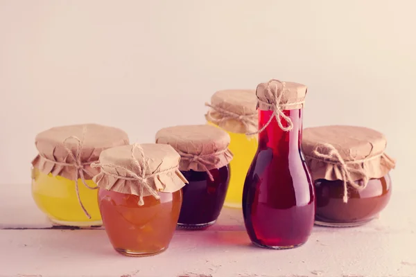 Preserved homemade fruits and berries jam in the jar. Rustic sty